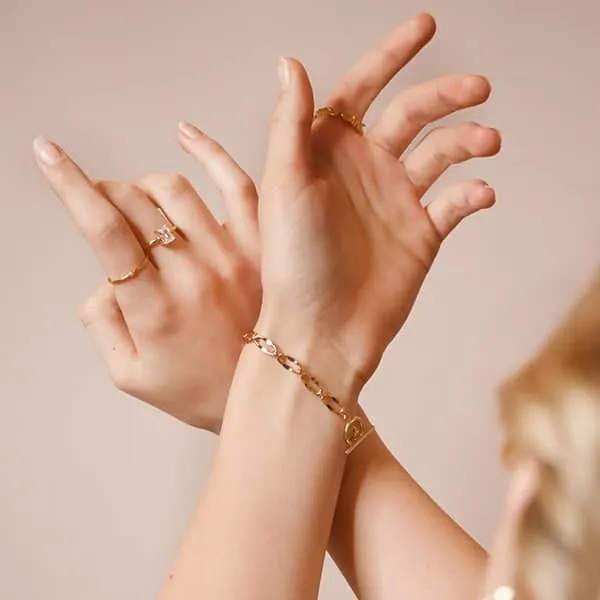 Gold rings and bracelet styled on hands